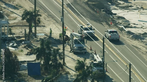 Aerial view service utility workmen repairing electricity lines  photo