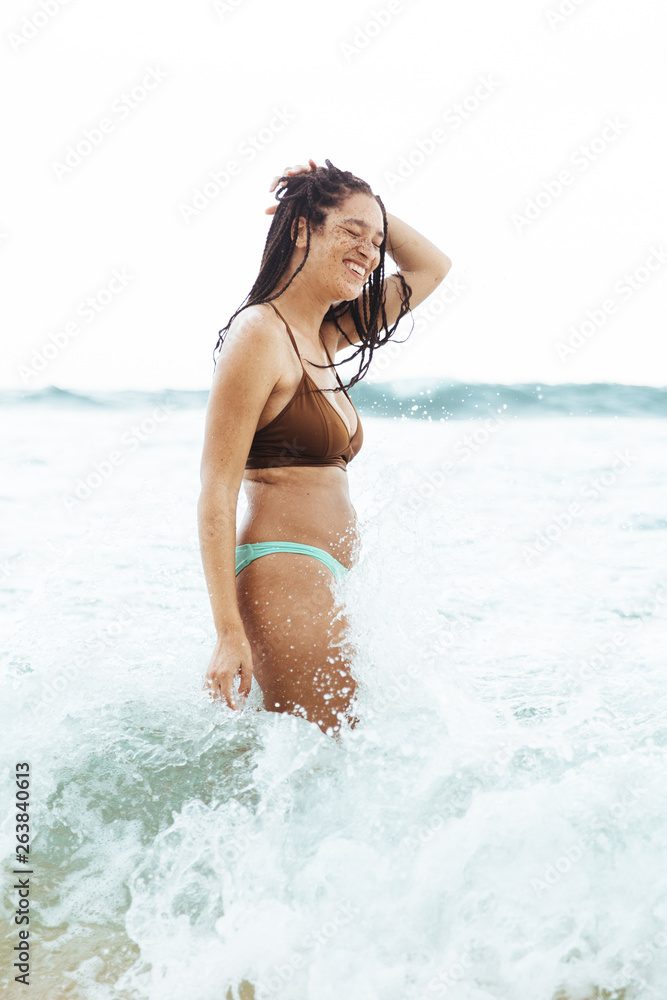 Woman Playing In The Waves On A Beach Woman Playing In The Waves On A Beach