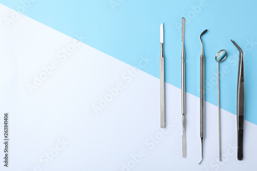Set of different dentist tools on color background, flat lay. Space for text photo
