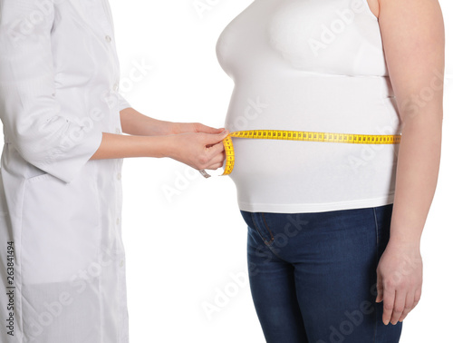 Doctor measuring waist of overweight woman isolated on white, closeup