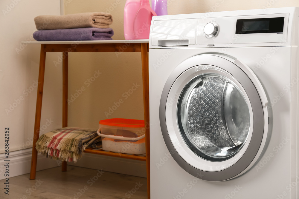 Modern white washing machine in laundry room Modern white washing machine in laundry room