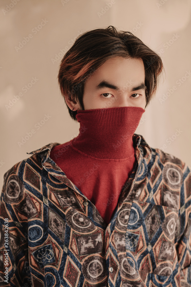 Asian man in turtleneck sweater Stock Photo | Adobe Stock