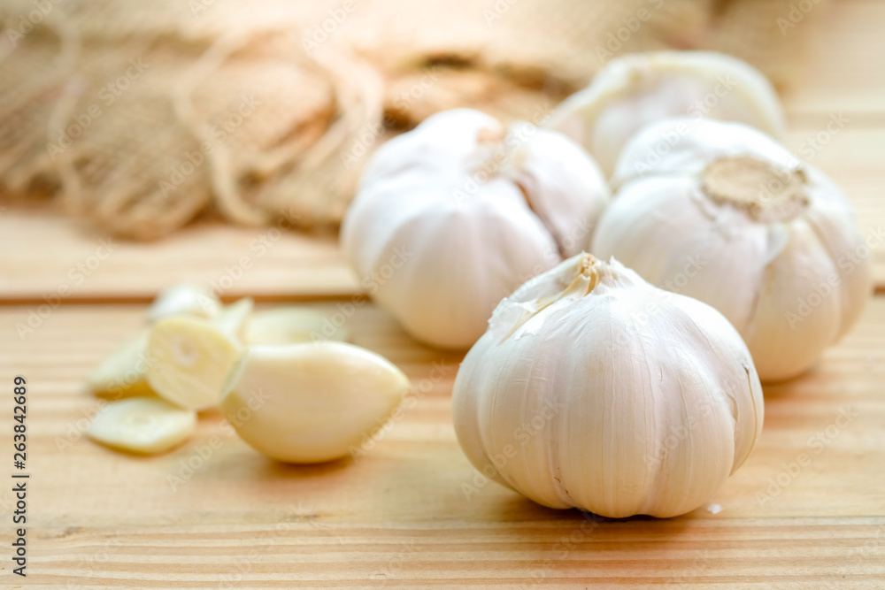 Garlic bulb head and cloves on wooden floor, Herbs and spices are important in cooking