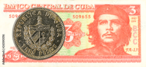 3 cuban peso coin against 3 cuban peso banknote photo