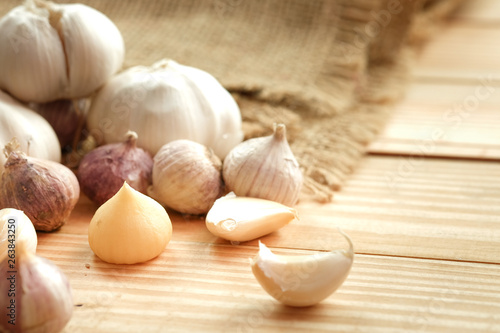Garlic bulb head and cloves on wooden floor  Herbs and spices are important in cooking
