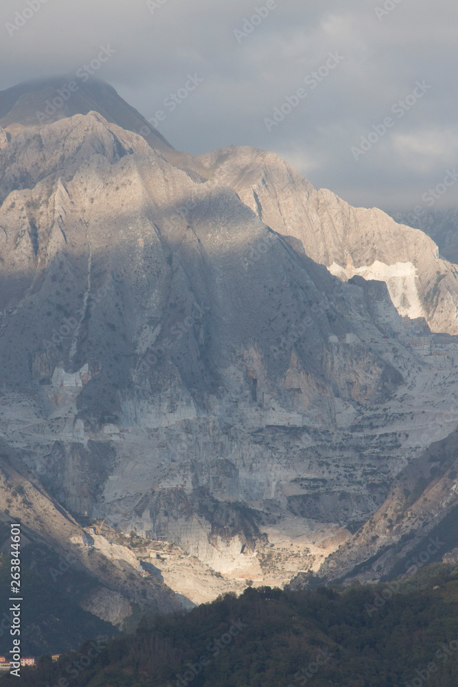 Obraz premium View of Carrara Marble Quarries and Apuani Mountains from Marina di Carrara Italy