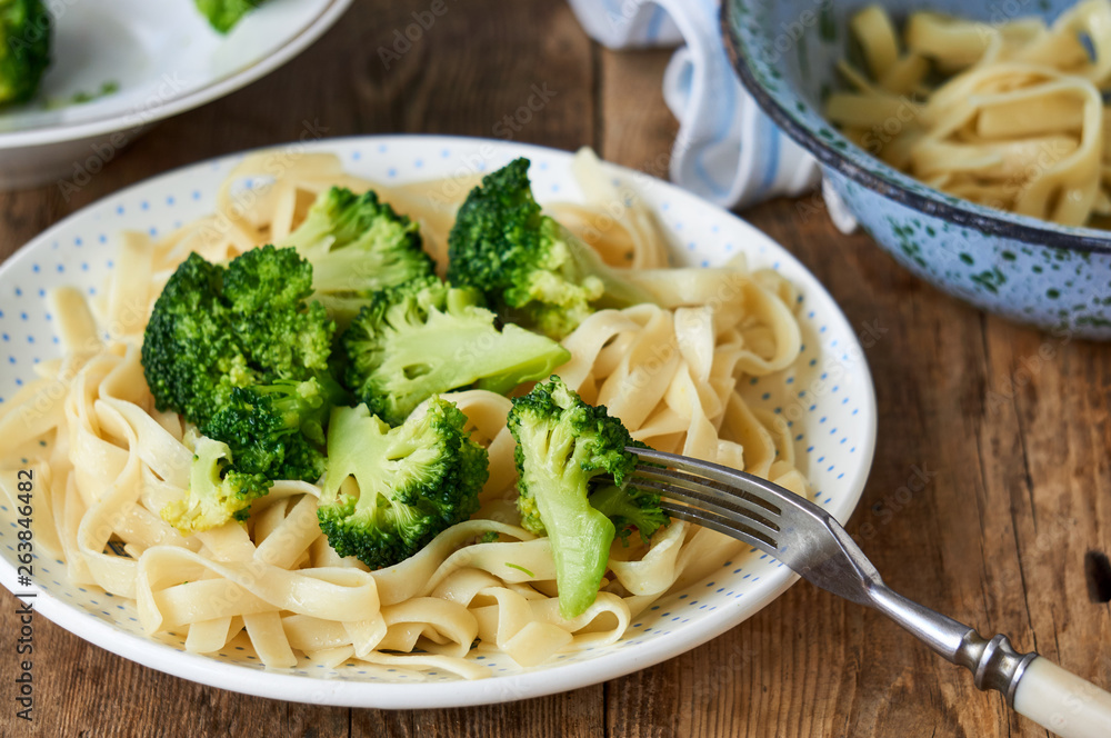 Noodles with boiled broccoli on a plate