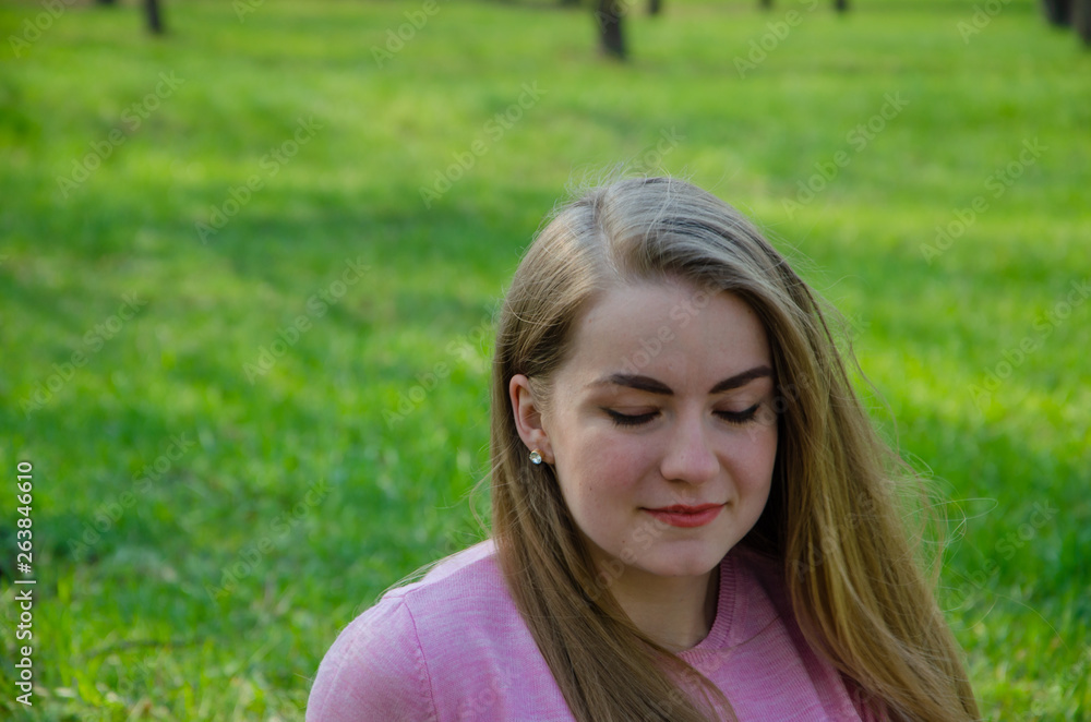 Portrait of a beautiful girl in bright pink clothes on a warm afternoon in the park Portrait of a beautiful girl in bright pink clothes on a warm afternoon in the park