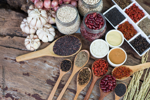 Cereal grains , seeds, beans,spices on wooden background. photo