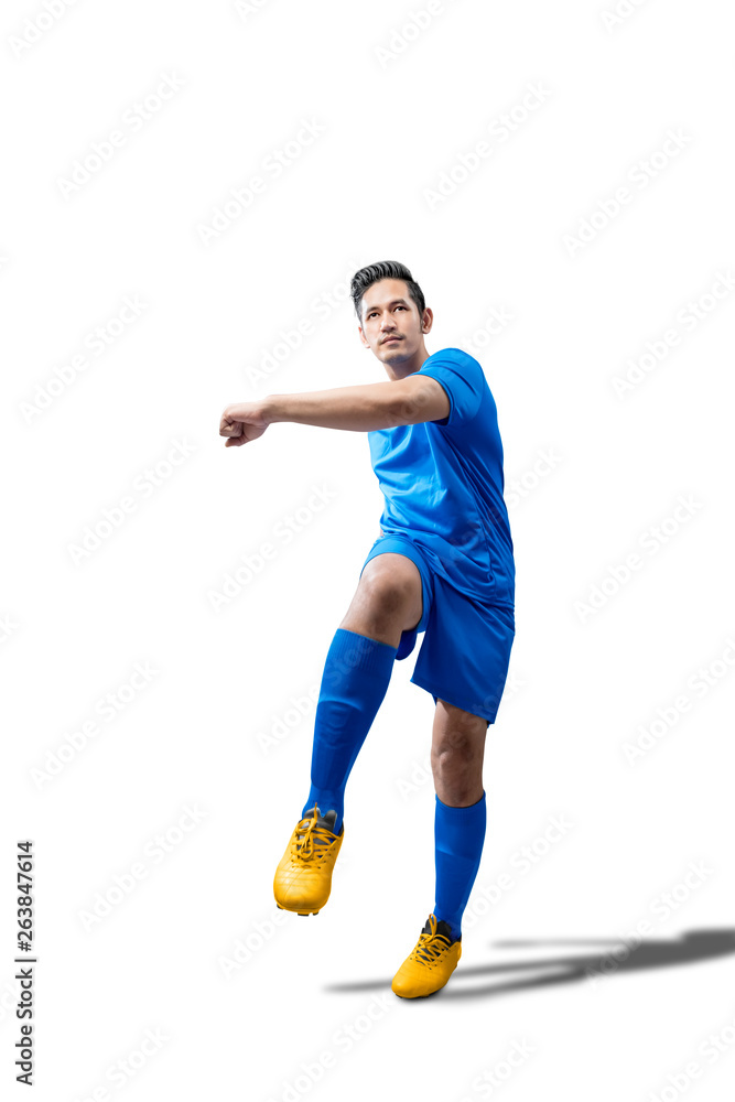 Fototapeta premium Portrait of asian football player man in blue jersey with kicking the ball position