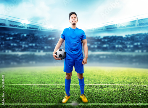 Asian football player man holding the ball in the middle