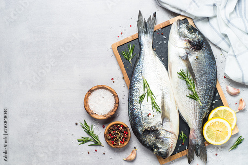 Photography Fresh fish dorado on blue background.