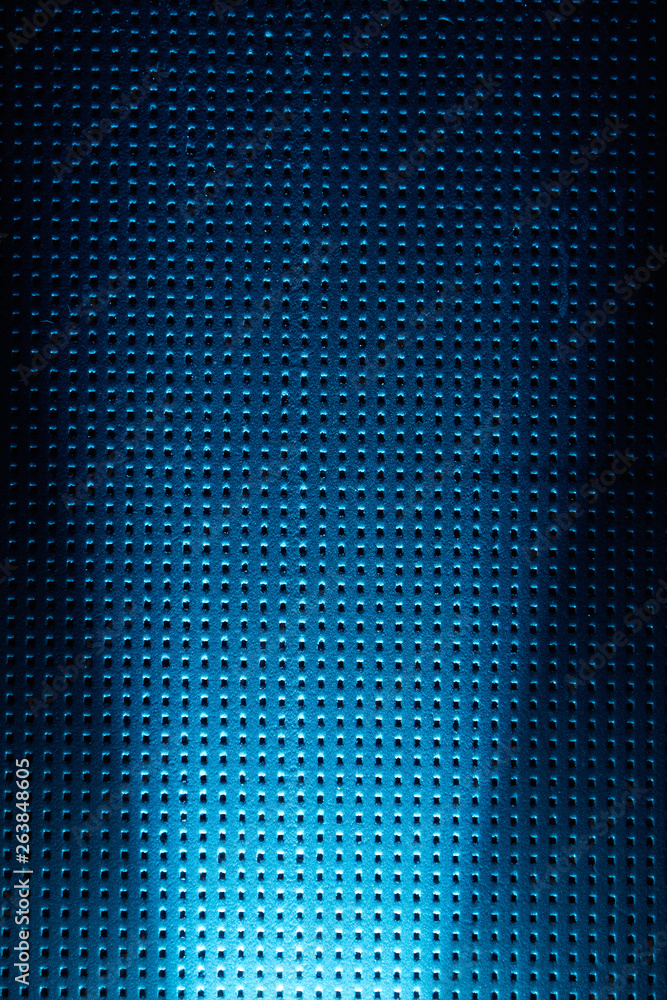 Vertical scattered blue ray on a dark blue background to a black dot Vertical scattered blue ray on a dark blue background to a black dot