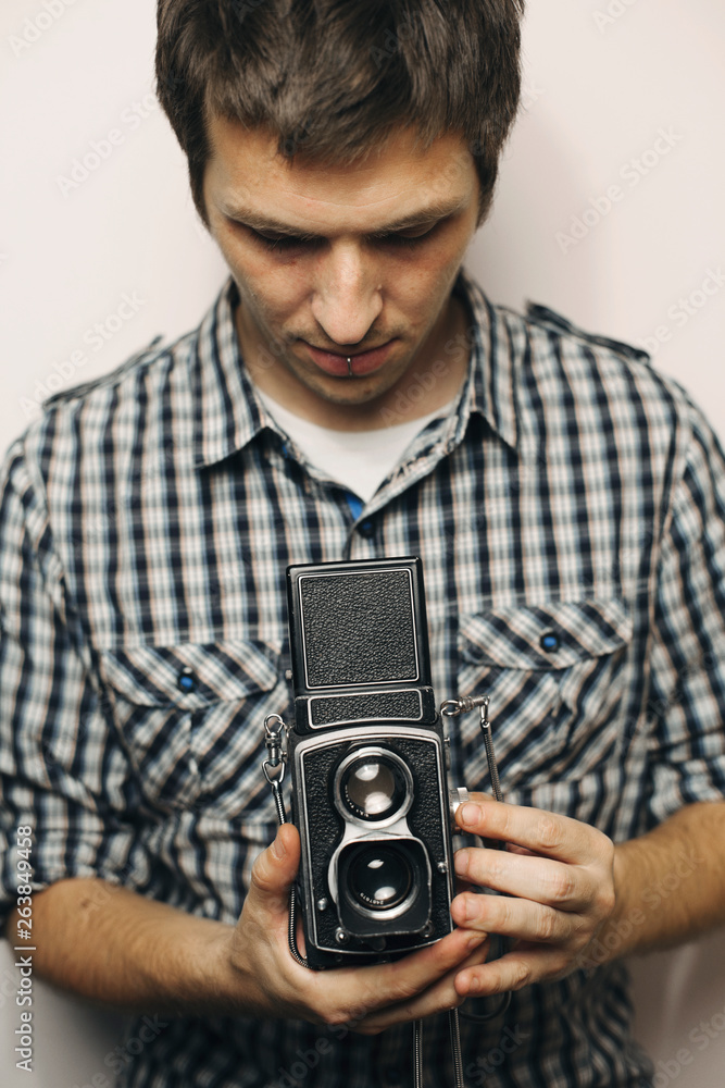 Young man holding retro analog camera Young man holding retro analog camera