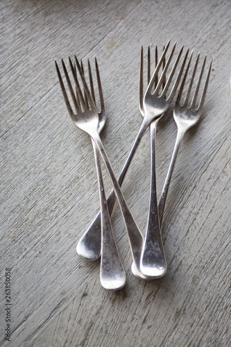 elegant antique forks on wooden table