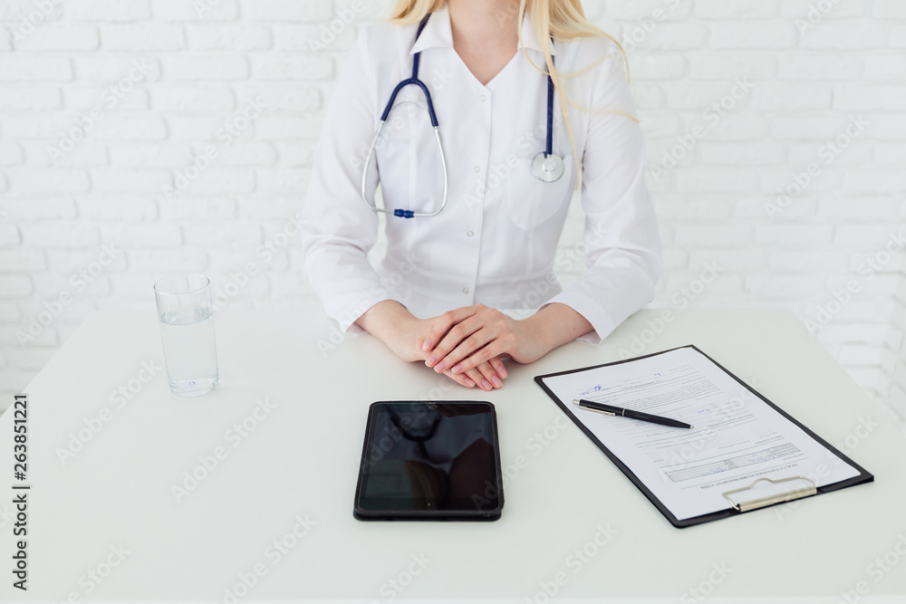 Unrecognizable female doctor advising patient in her medical office Unrecognizable female doctor advising patient in her medical office