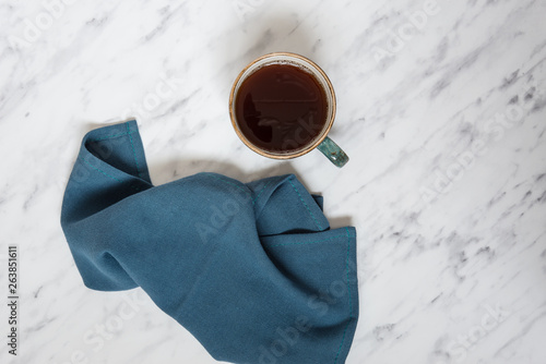 Cup of coffee and blue napkin
