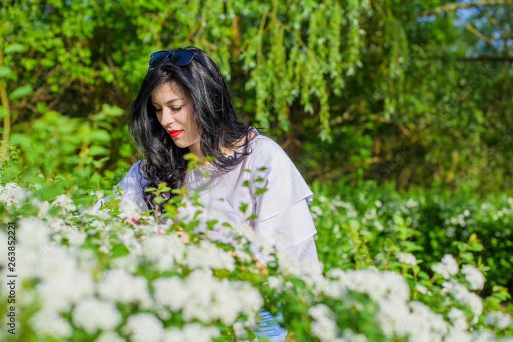 Romantic woman at spring blossom garden. Concept of woman and tenderness, modern beauty or femininity Romantic woman at spring blossom garden. Concept of woman and tenderness, modern beauty or femininity
