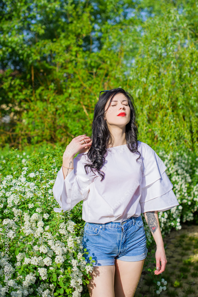 Romantic woman at spring blossom garden. Concept of woman and tenderness, modern beauty or femininity Romantic woman at spring blossom garden. Concept of woman and tenderness, modern beauty or femininity
