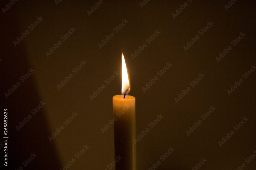 Burning Candle against dark background Burning Candle against dark background