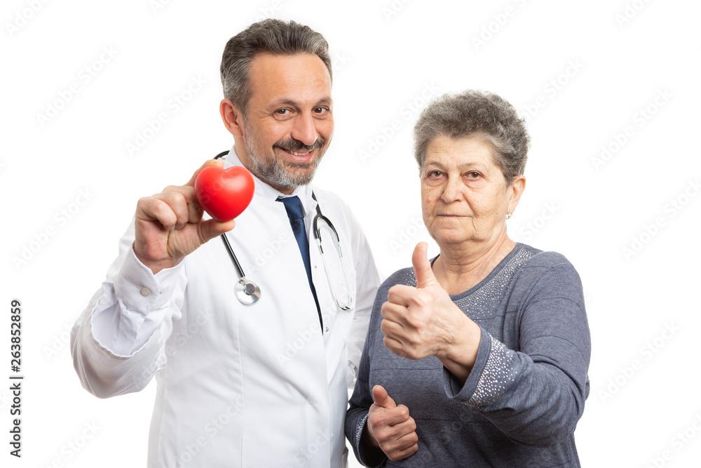 Cardiologist showing heart and patient holding thumb up Cardiologist showing heart and patient holding thumb up