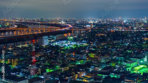 time lapse of cityscape and highway road bridge in Tokyo at night, Japan photo