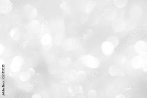 A brilliant white background with circles and ovals. Template for a holiday card with bright and sparkling lights.