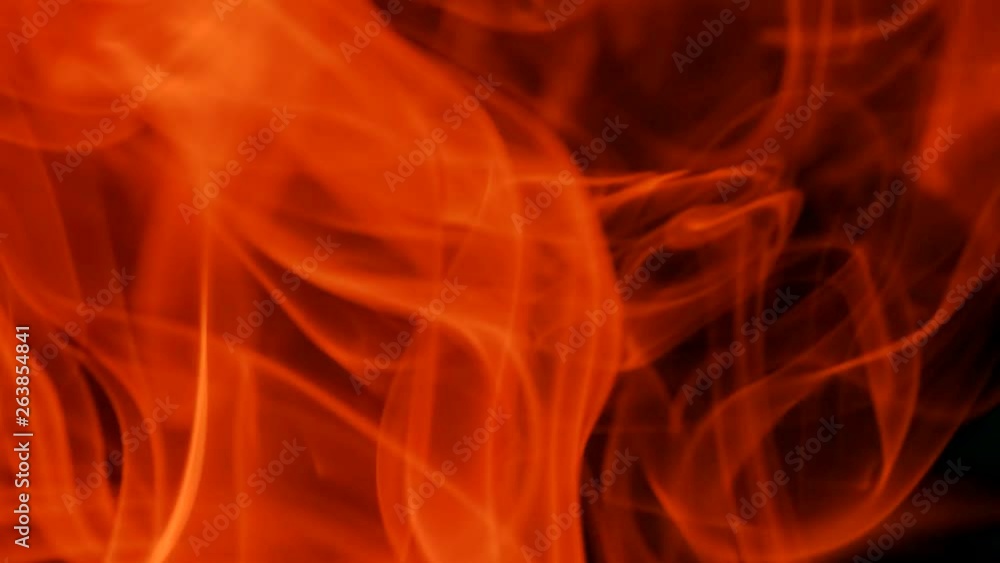 Thin trickle of red smoke slowly rising graceful twists up on black background. Colored smoke blowing from bottom to top. Closeup Thin trickle of red smoke slowly rising graceful twists up on black background. Colored smoke blowing from bottom to top. Closeup
