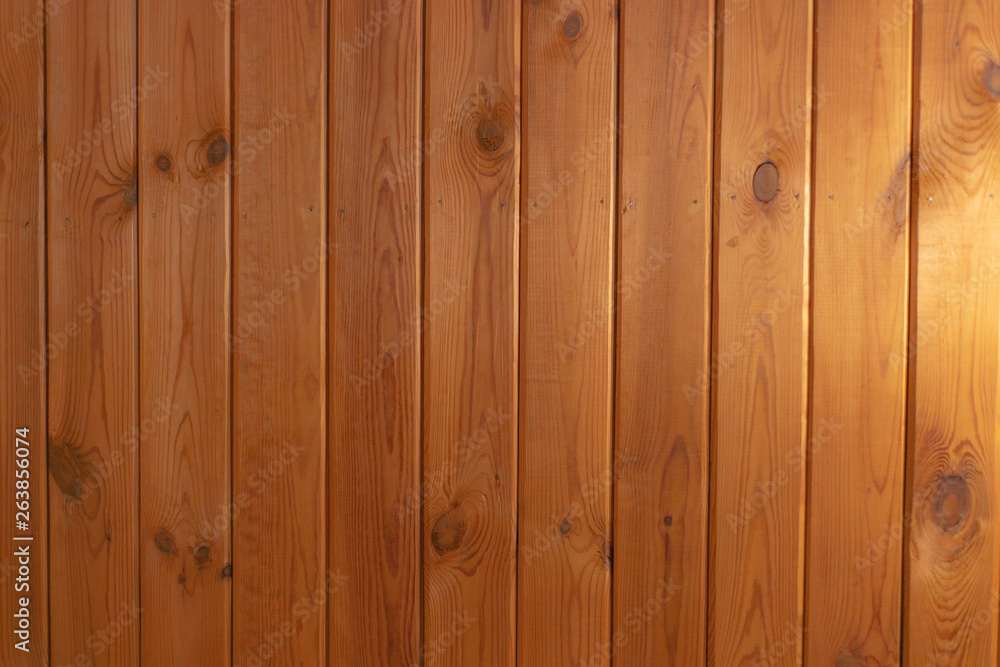 grunge background: plank surface, varnished boards, yellow illumination on the right grunge background: plank surface, varnished boards, yellow illumination on the right