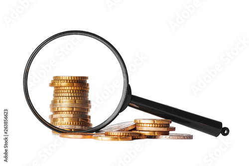 double exposure business concept with magnifying glass zoom and focus on coins money idea for finance photo