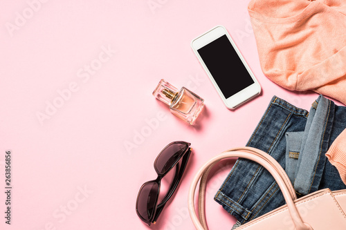 Woman flat lay background with cloth, accerrories and cosmetics.  photo
