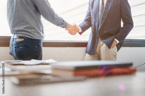 Business people shaking hands in meeting room, Successful deal after meeting.