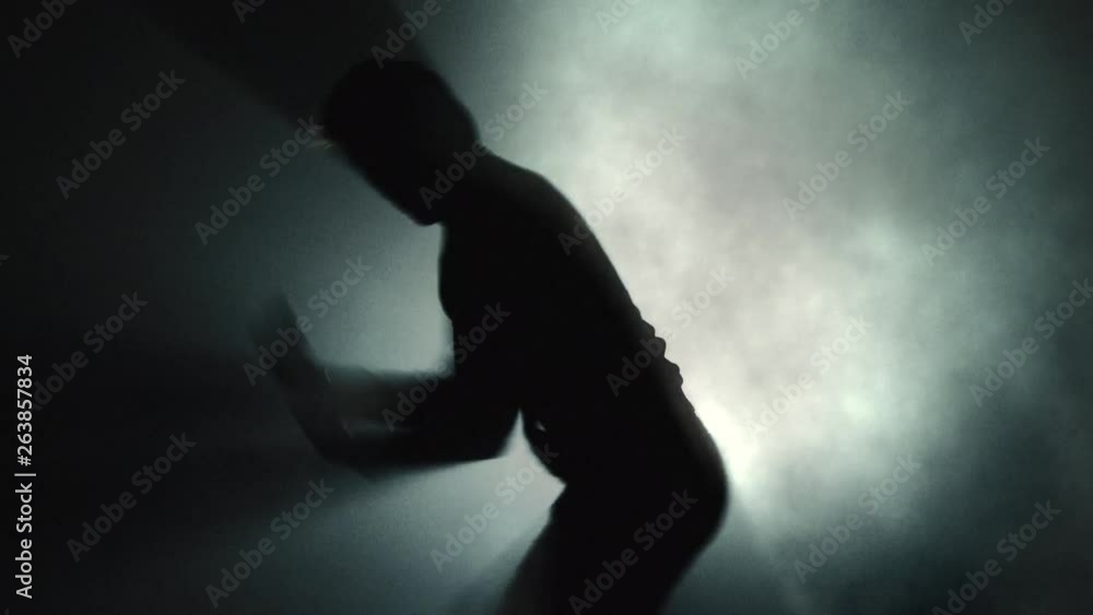 Man Air Boxing - Anger Concept - Silhouette on Dark Smoky Background Man Air Boxing - Anger Concept - Silhouette on Dark Smoky Background