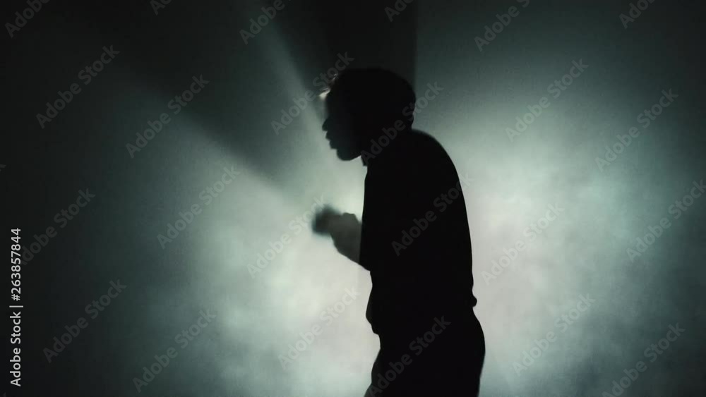 Man Air Boxing - Anger Concept - Silhouette on Dark Background Man Air Boxing - Anger Concept - Silhouette on Dark Background
