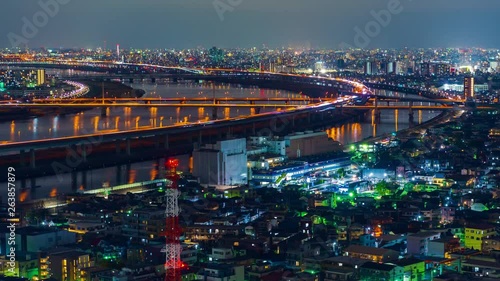 time lapse of cityscape and highway road bridge in Tokyo at night, Japan photo