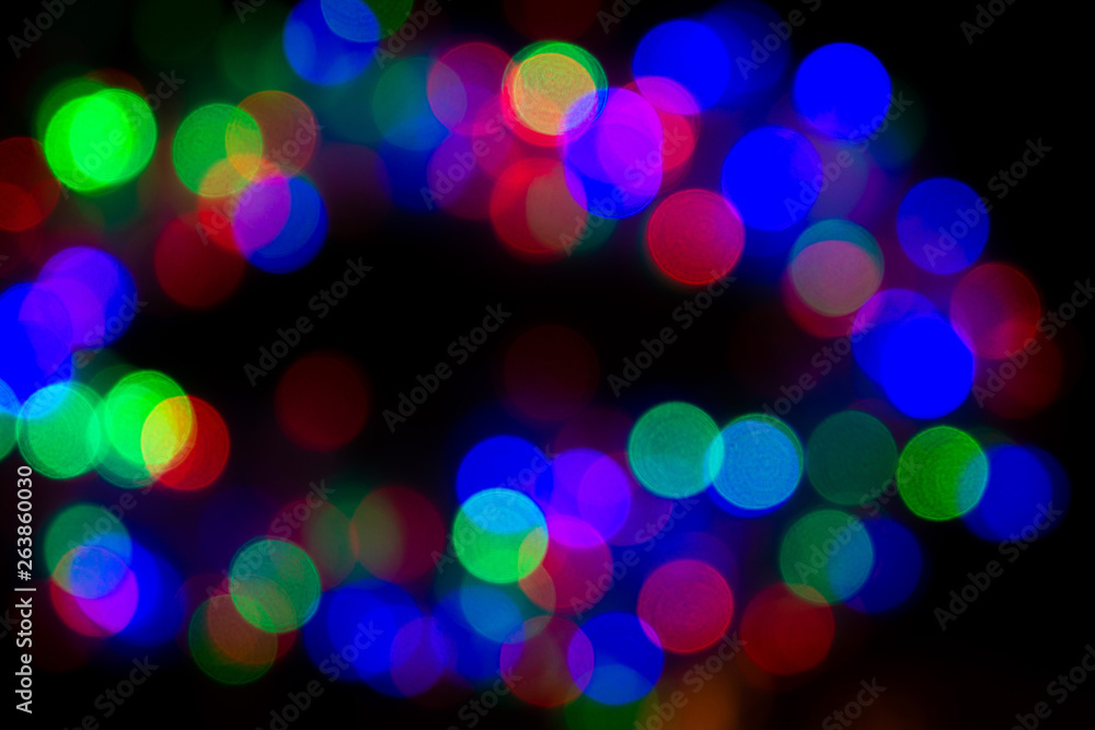 dark background with glowing multicolored lights in defocus, bokeh
