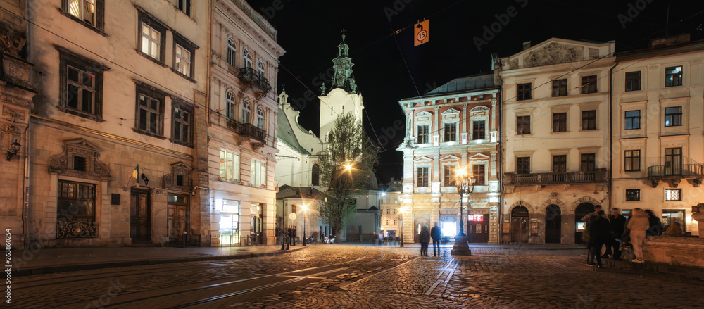 Lviv panorama at night. View of the night street of the European medieval city. Lviv Market square at night.  Concept  - travel, landmarks, monument of architecture, world heritage. Long exposure