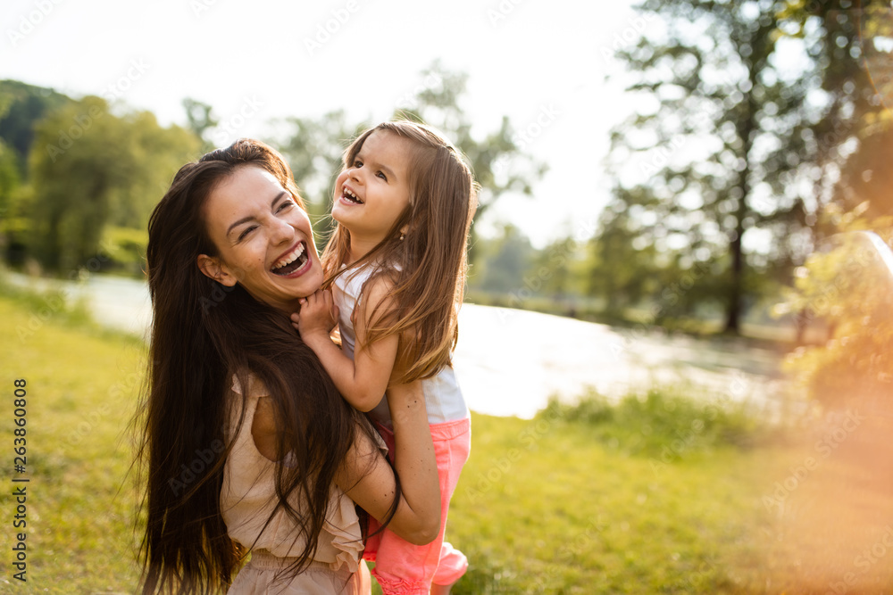 Joyous mother holding little girl in arms Joyous mother holding little girl in arms
