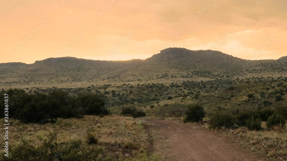 Moving towards a golden sun set over a mountain range on the horizon in Texas, slow motion 24 fps. Moving towards a golden sun set over a mountain range on the horizon in Texas, slow motion 24 fps.