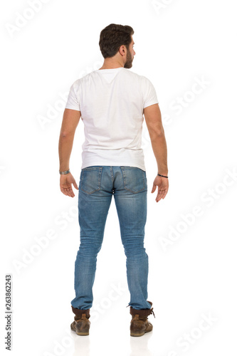 Rear View Of Standing Man In Jeans And WhiteT-shirt