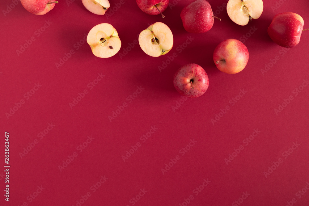 Red apples on a red background. Flat lay, top view, copy space Red apples on a red background. Flat lay, top view, copy space