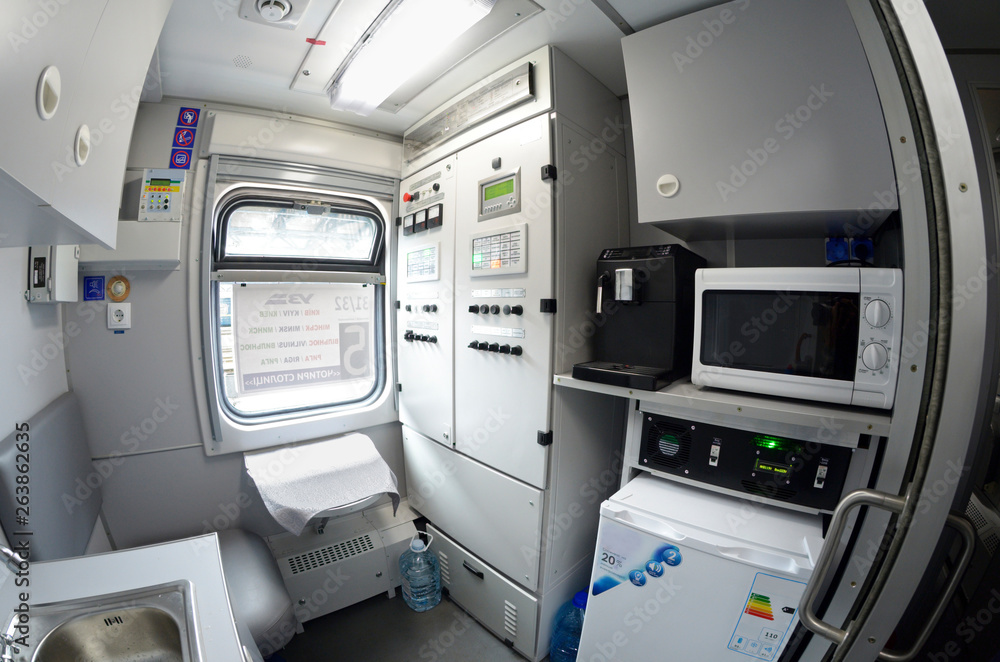 Interior of a service compartment of a wagon (conductor’s): seat, window, electrical stove, refrigerator, washbasin, control panel Interior of a service compartment of a wagon (conductor’s): seat, window, electrical stove, refrigerator, washbasin, control panel