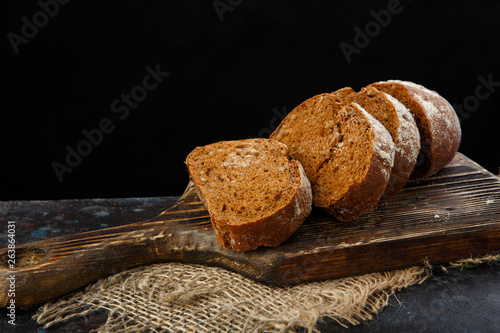 Home-made bread from rye flour, with seeds on old wooden Board