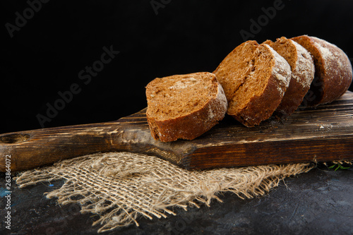 Fresh homemade bread on wooden plank,  food close up