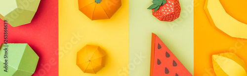 panoramic shot of various handmade origami fruits on colorful paper stripes