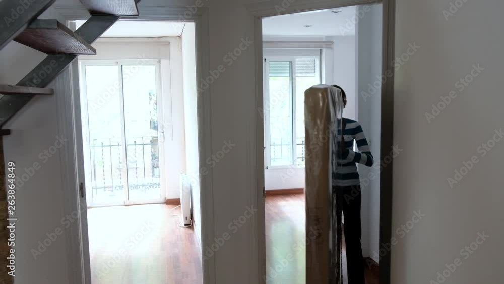 Asian girl pushes and pulls a mattress from one room to another. Asian girl pushes and pulls a mattress from one room to another.