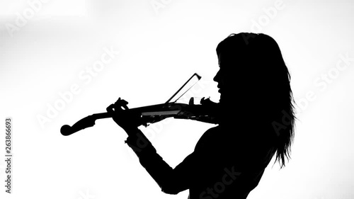 black silhouette on white background young girl in tight black leather clothes expressively plays the electric violin