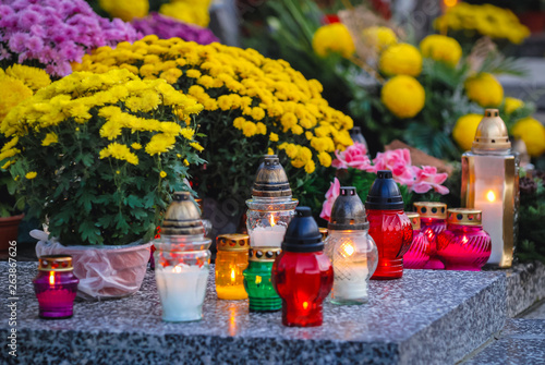 Candles on a grave in Wola Cemetery in Warsaw city, Poland during All Saints Day
