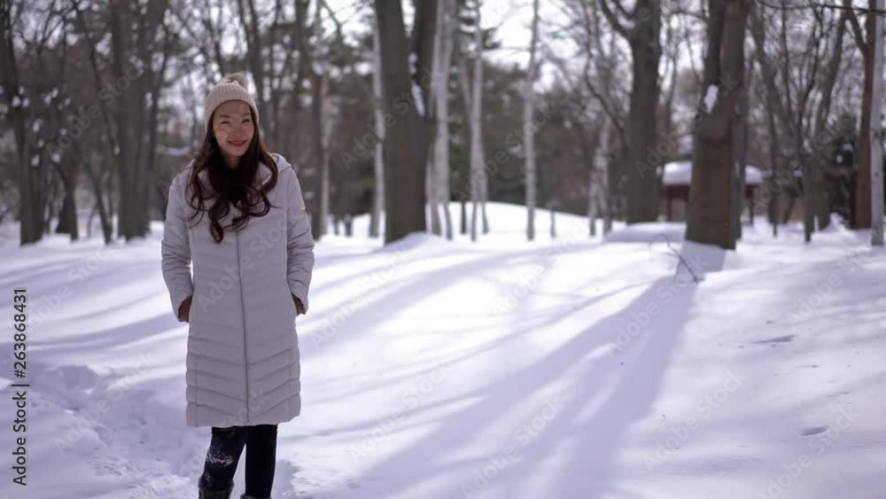 Snow winter woman portrait in a forest on snowy white winter day. Beautiful asian girl smiling happy outside. Snow winter woman portrait in a forest on snowy white winter day. Beautiful asian girl smiling happy outside.