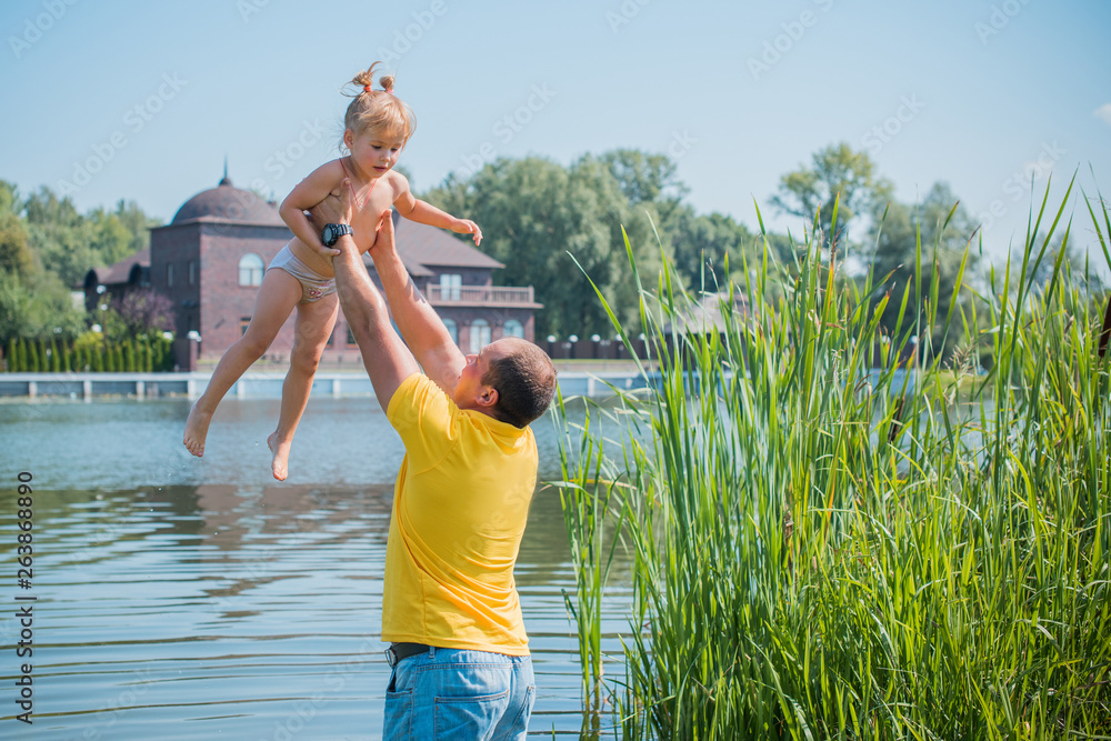 Obraz premium Concept of children life. Little child having fun in a beach. Happy child playing in the nature . Kid having fun outdoors. Summer vacation and healthy lifestyle 